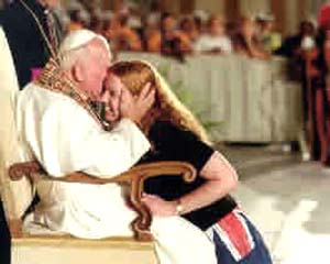 Pope John Paul II kissing the side of a young womans head